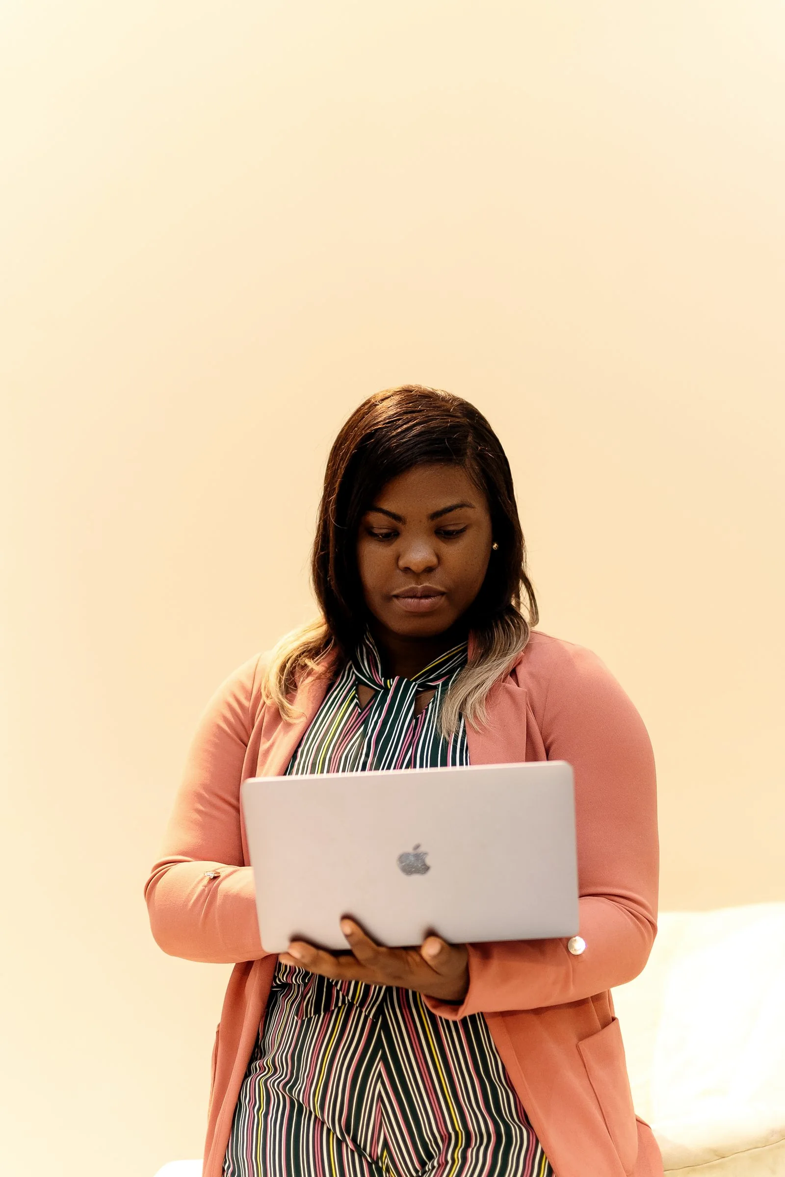 African professional developing brand ideas on a laptop
