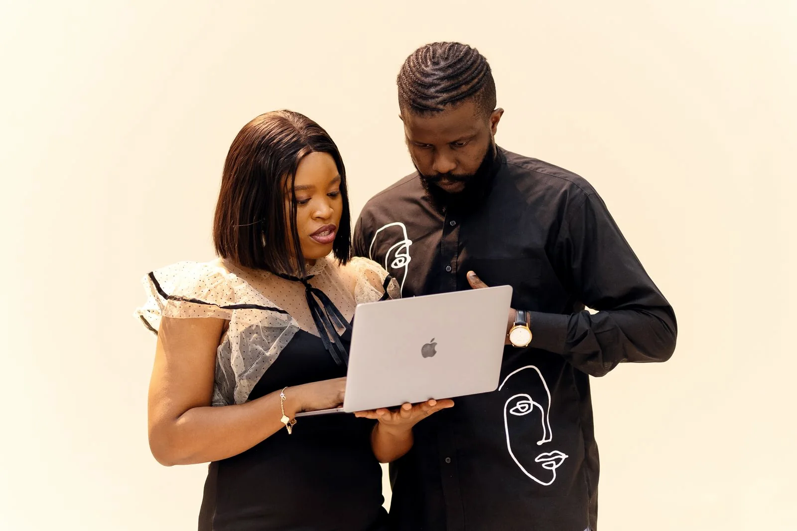 African business partners collaborating with a laptop