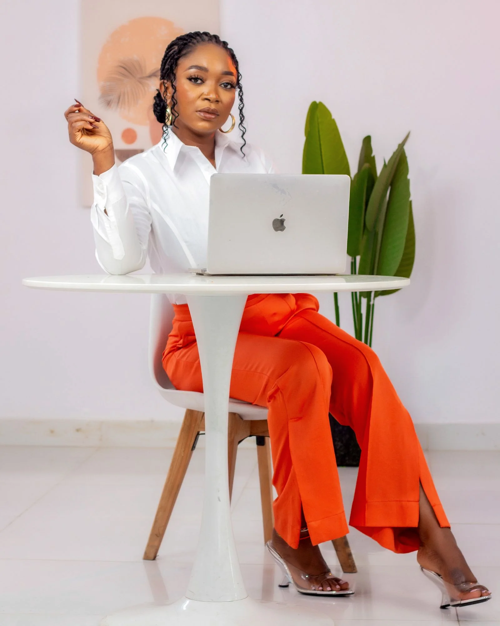 Confident African entrepreneur working on a laptop in a modern studio